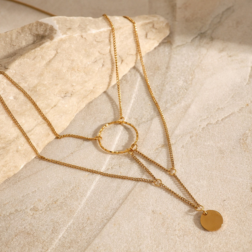 amethyst & sable aurea cascade necklace in 18k gold on stone surface