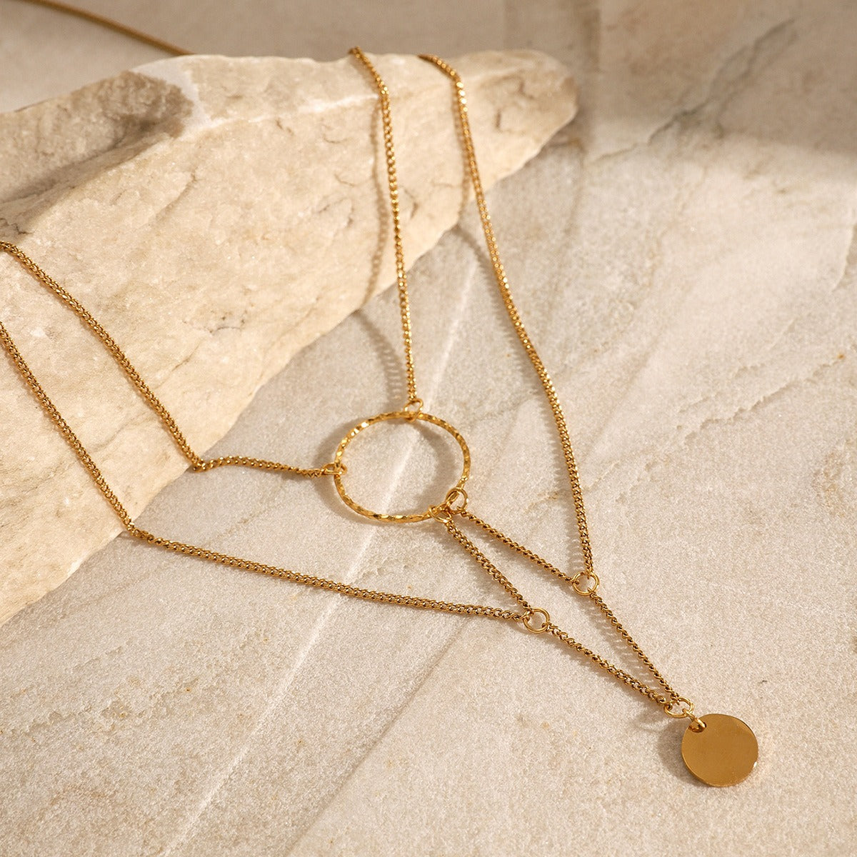 amethyst & sable aurea cascade necklace in 18k gold on stone surface