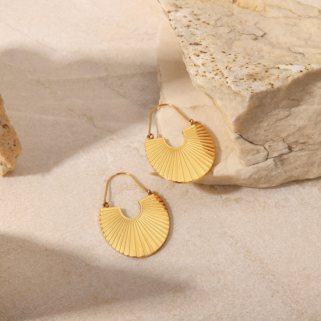 amethyst & sable calypso fan earrings in 18k gold on stone surface