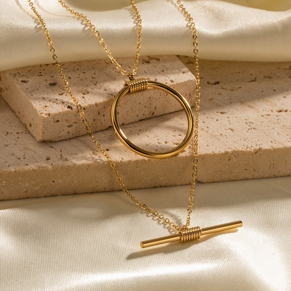 amethyst & sable axis balance necklace in 18k gold on stone and satin surface