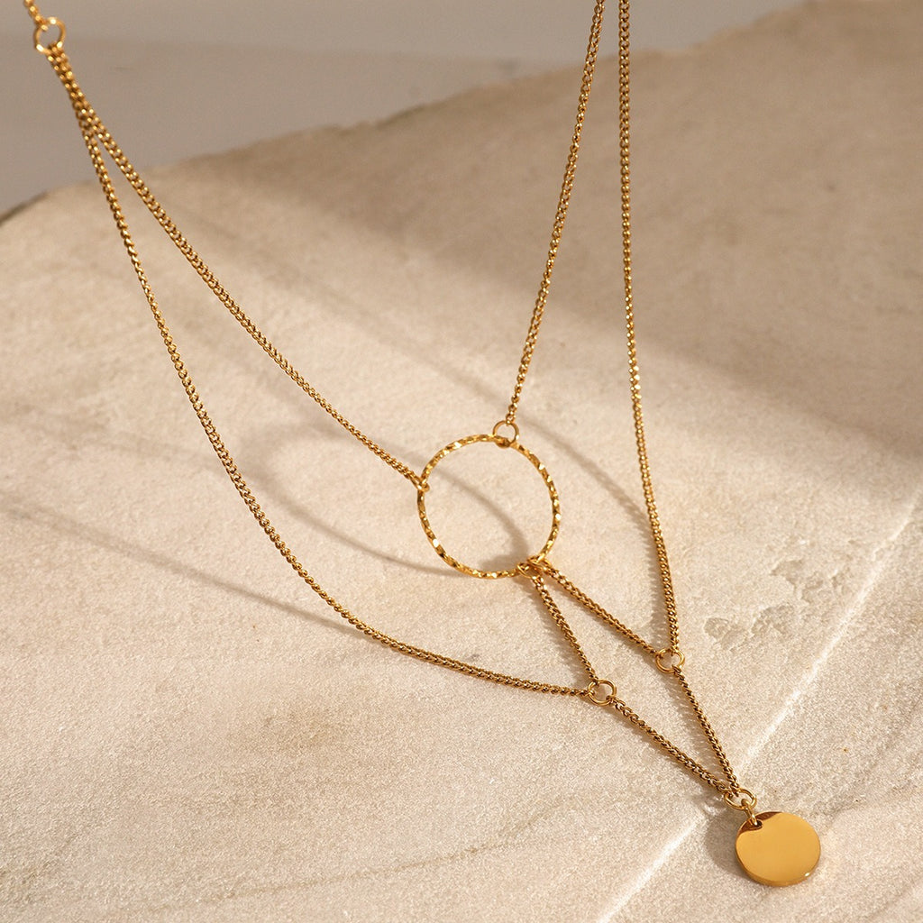 amethyst & sable aurea cascade necklace in 18k gold on stone surface