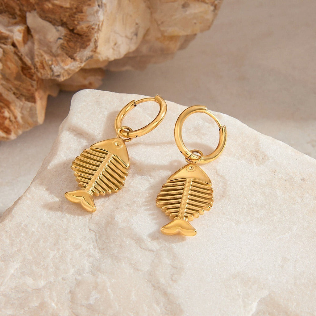 amethyst & sable Calypso Marina Drop Earrings in 18k gold on stone surface