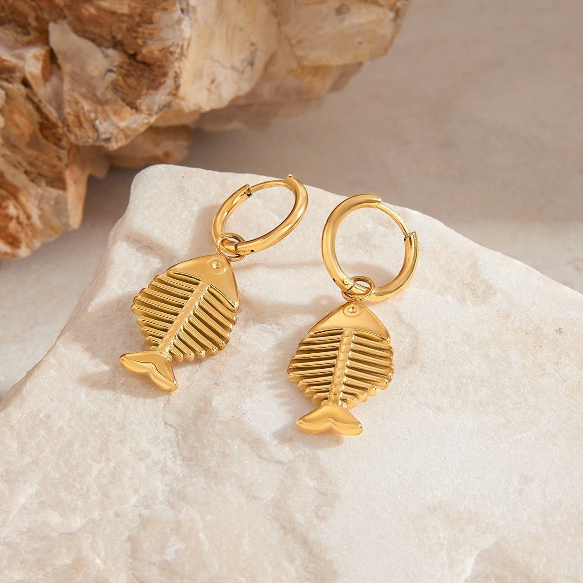 amethyst & sable Calypso Marina Drop Earrings in 18k gold on stone surface