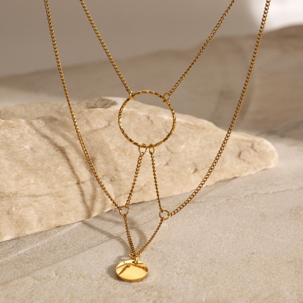 amethyst & sable aurea cascade necklace in 18k gold on stone surface
