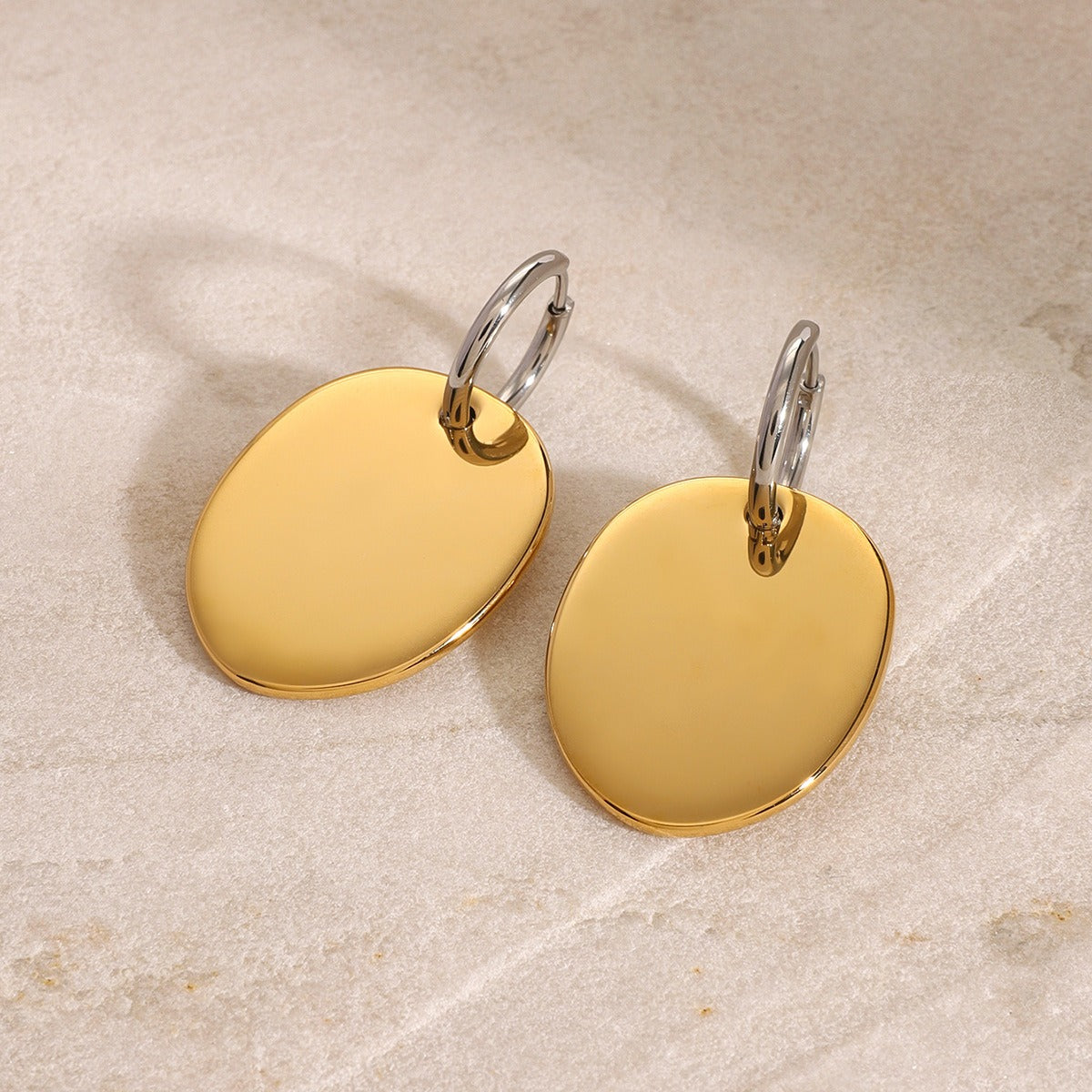 amethyst & sable aurea disc drop earrings in 18k gold on stone surface