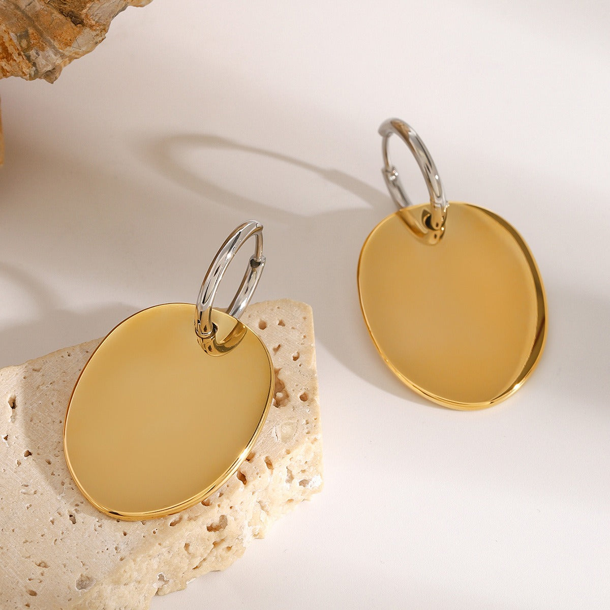 amethyst & sable aurea disc drop earrings in 18k gold on stone surface
