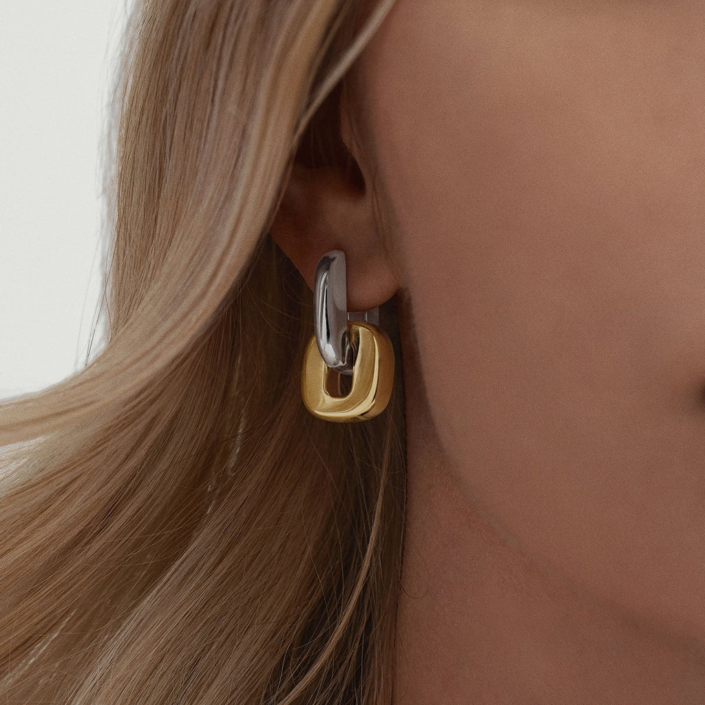 model wearing amethyst & sable axis frame earrings in mixed metal 18k gold and stainless steel