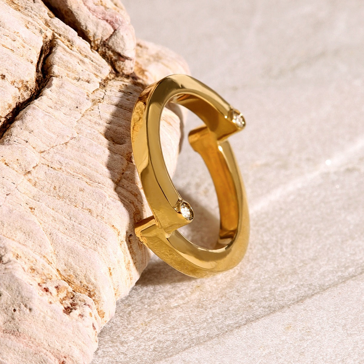 amethyst & sable axis orbit ring in gold on stone surface