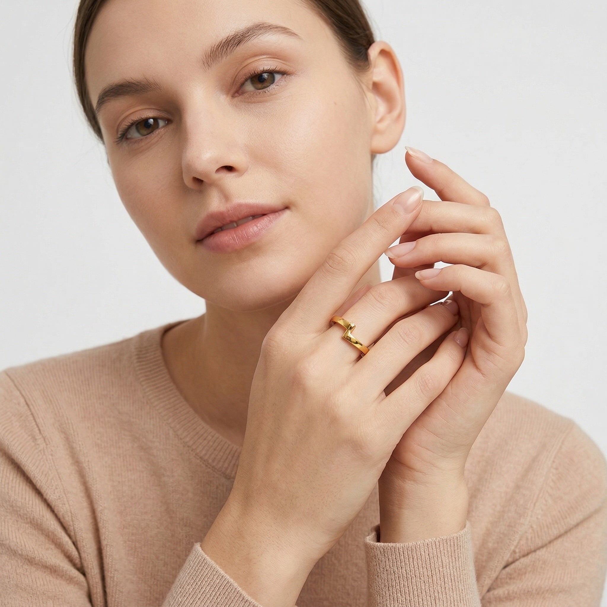 model wearing amethyst & sable axis orbit ring in gold