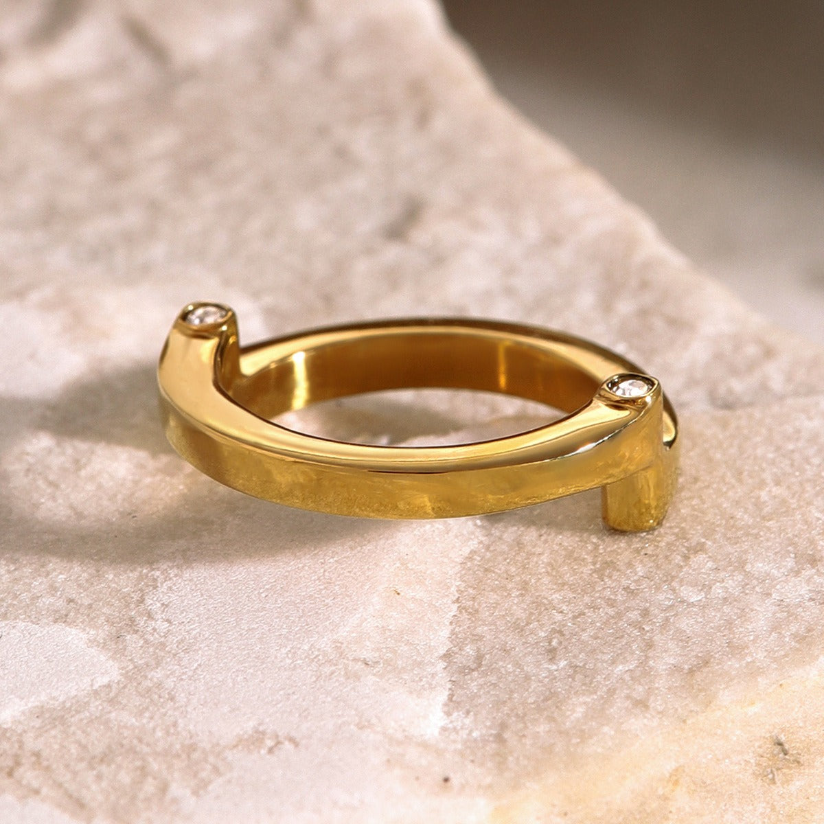 amethyst & sable axis orbit ring in gold on stone surface