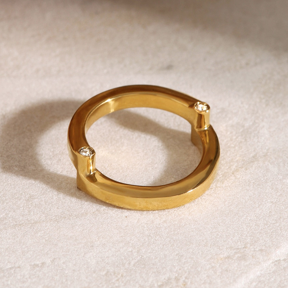 amethyst & sable axis orbit ring in gold on stone surface