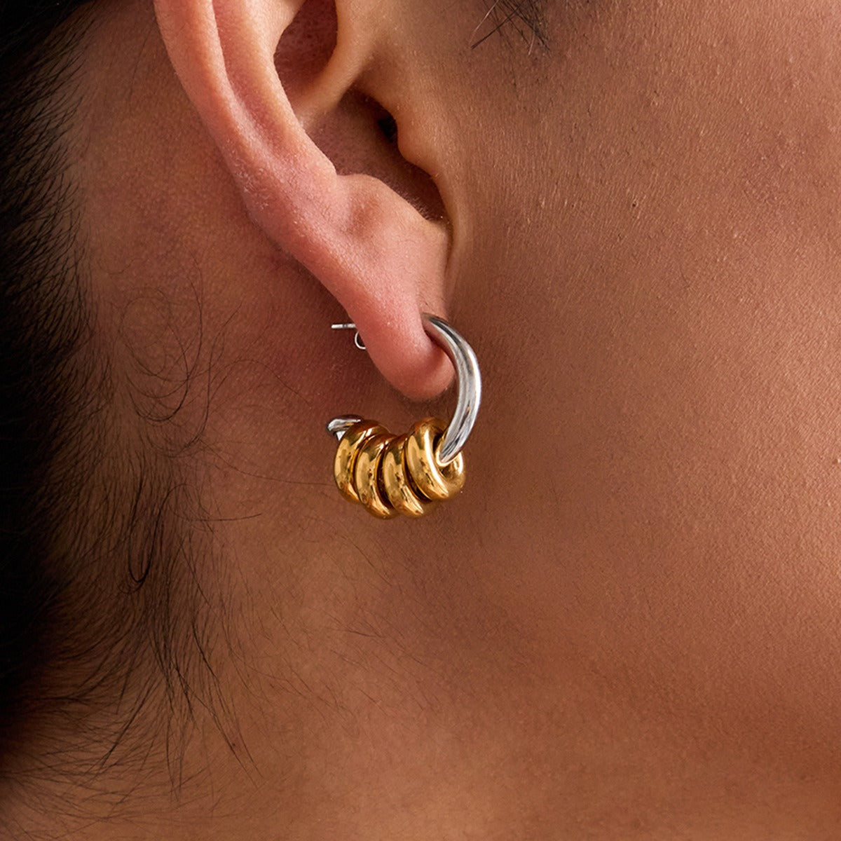 model wearing amethyst & sable axis rhythm earrings in 18k gold and stainless steel mixed metal