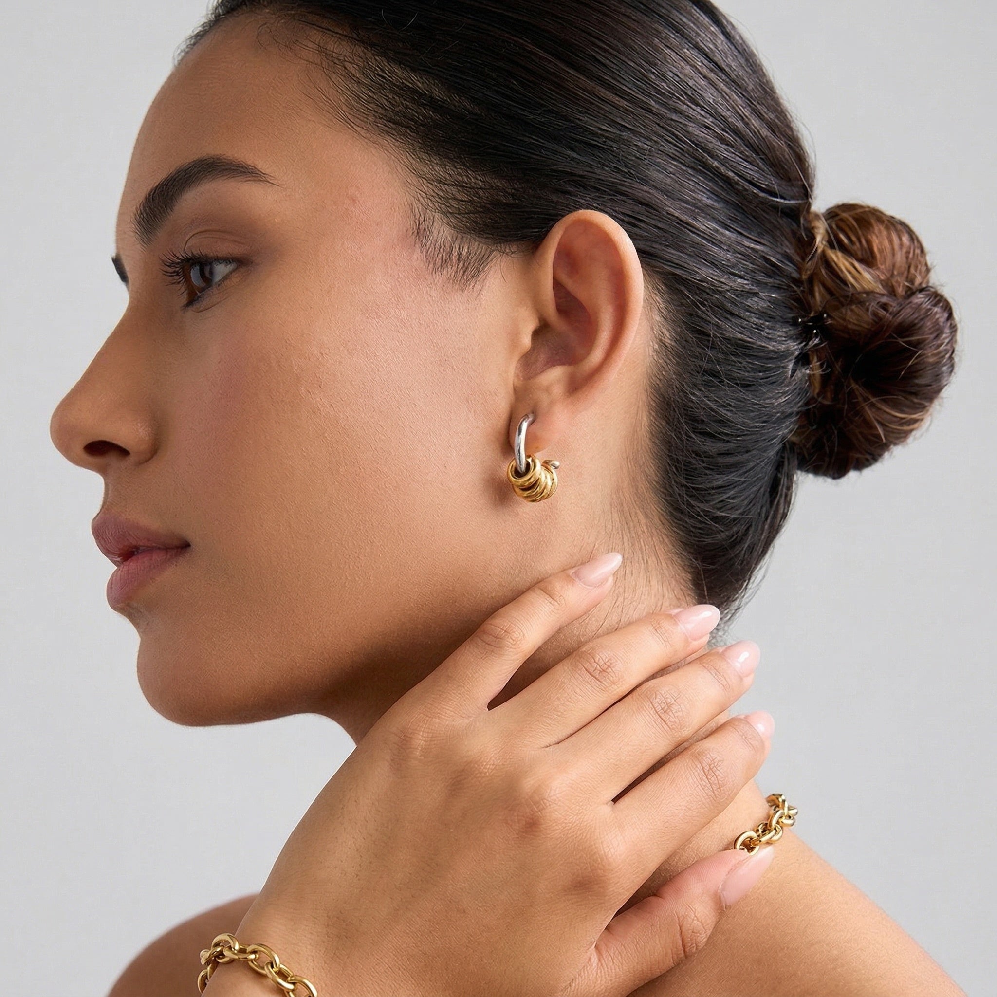 model wearing amethyst & sable axis rhythm earrings in 18k gold and stainless steel mixed metal