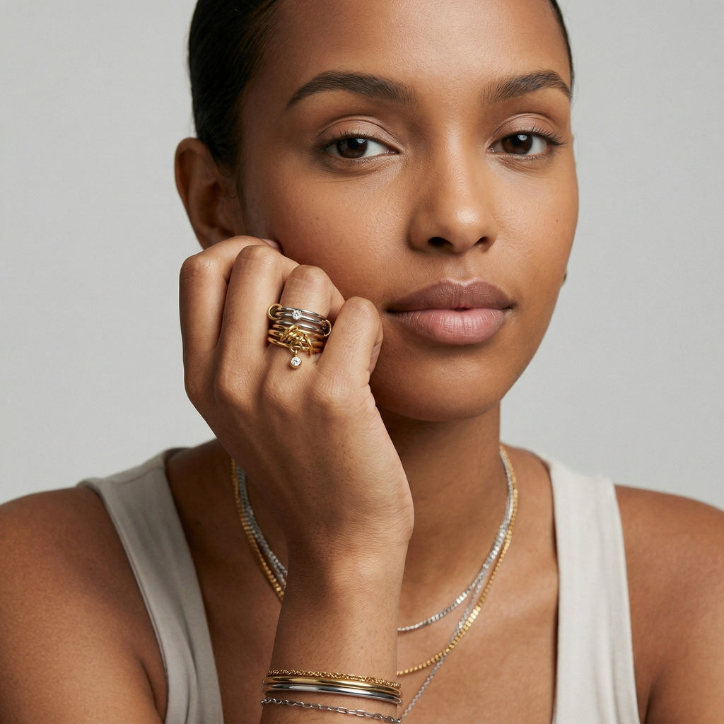 model wearing amethyst & sable axis stack rings in 18k gold and stainless steel mixed metal