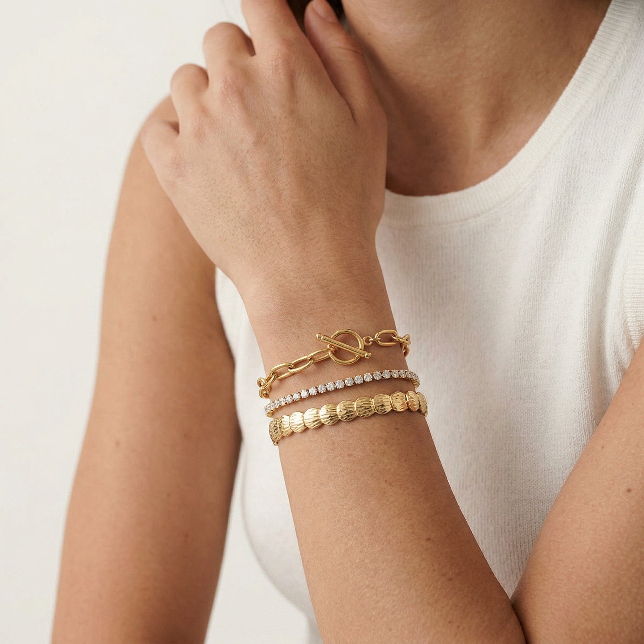 model wearing amethyst & sable axis trinity stack in 18k gold