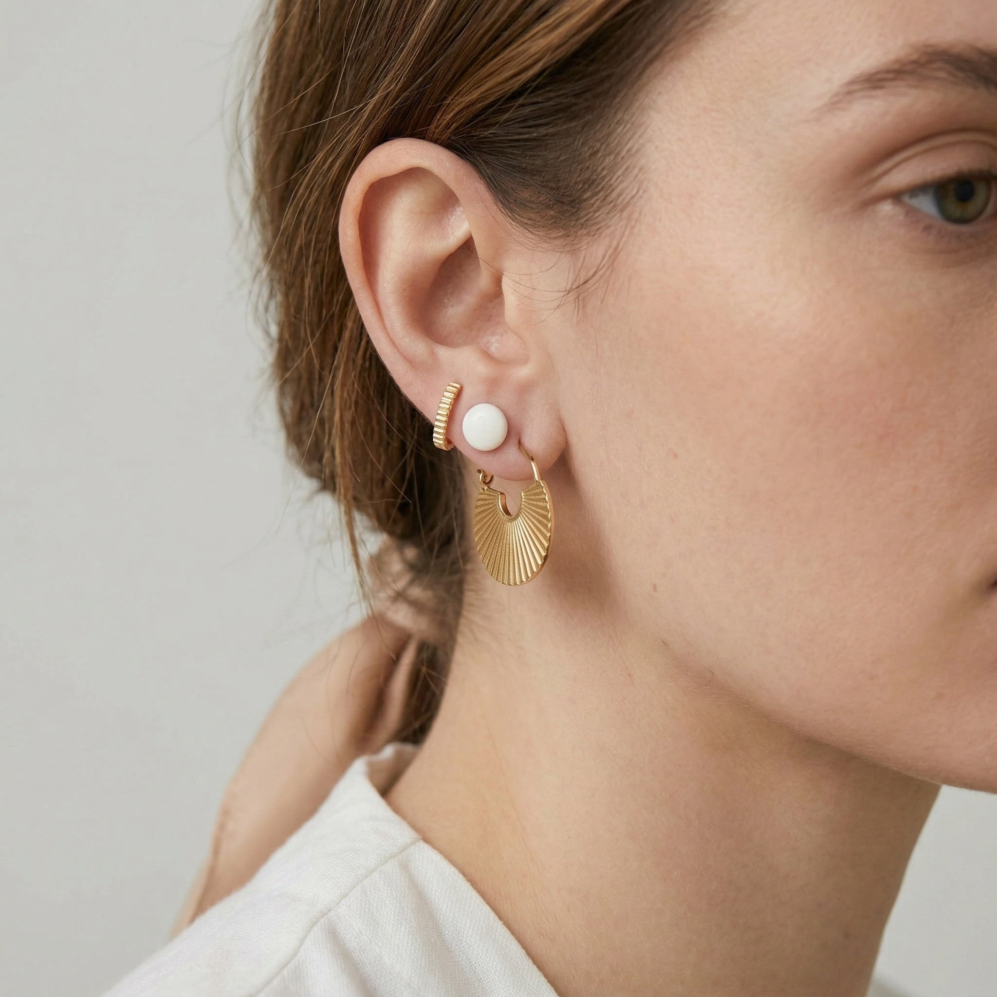 model wearing amethyst & sable calypso fan earrings in 18k gold