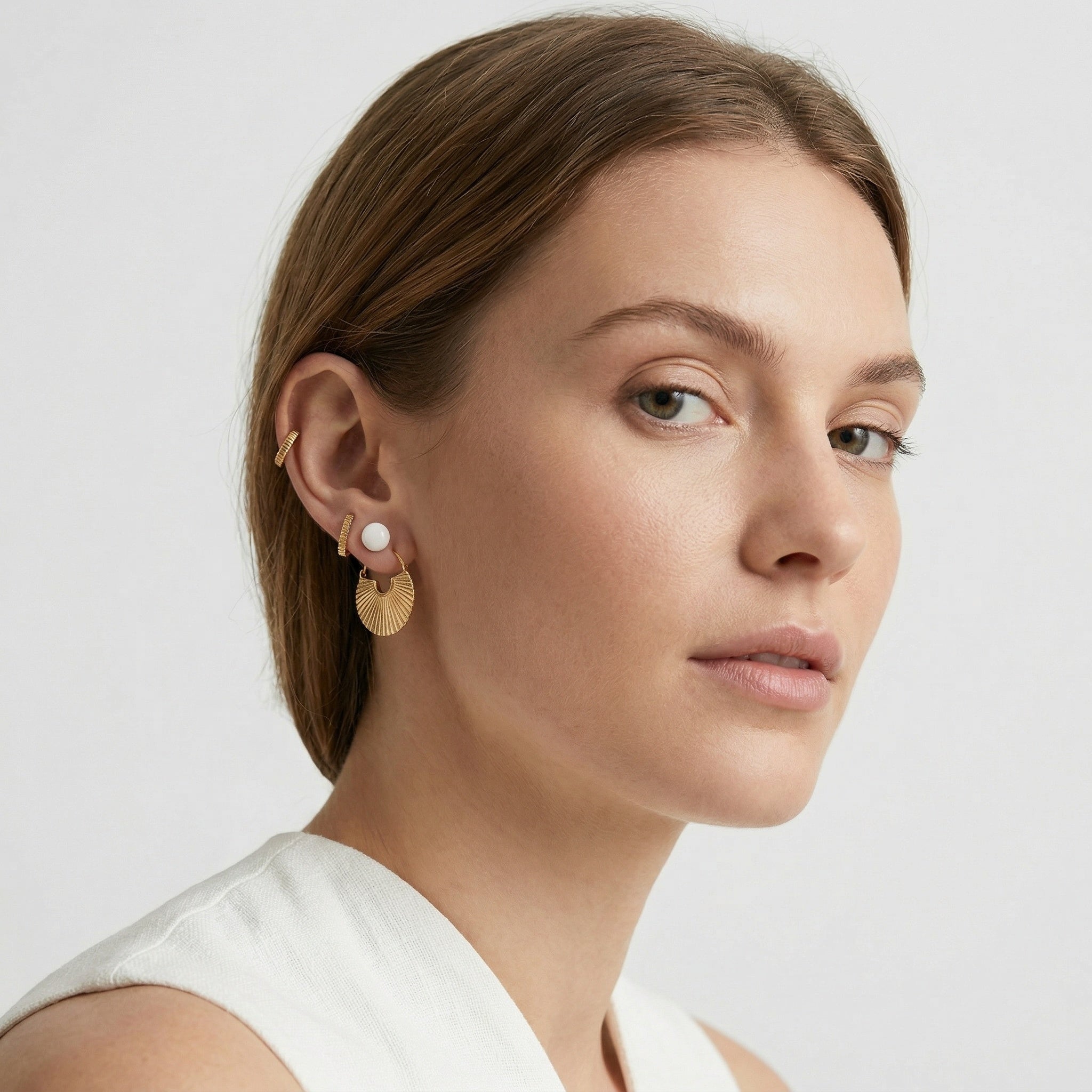 model wearing amethyst & sable calypso fan earrings in 18k gold