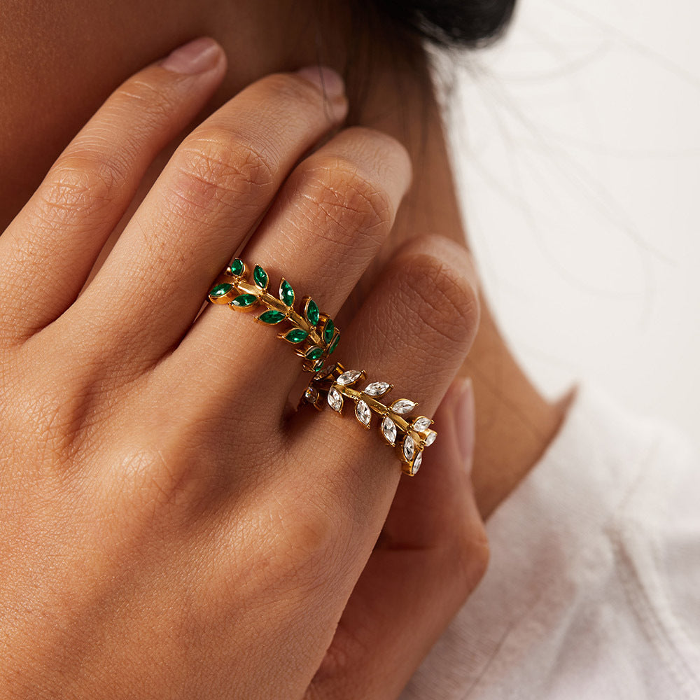 model wearing amethyst & sable calypso fern rings in 18k gold crystal and emerald