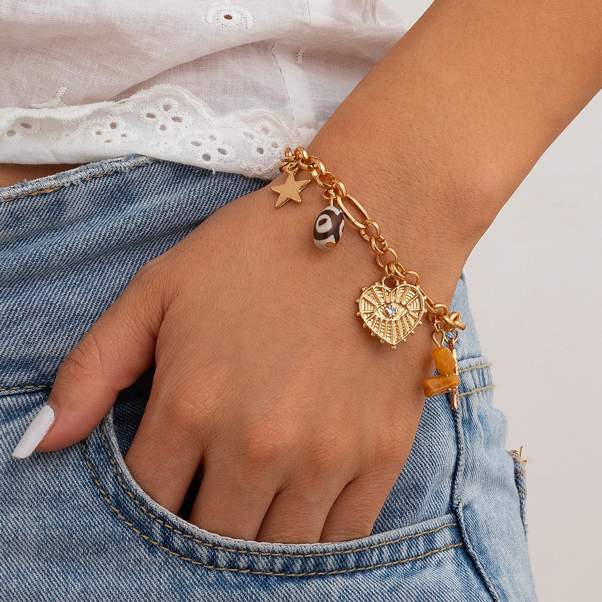 model wearing amethyst & sable calypso keepsake bracelet in 18k gold