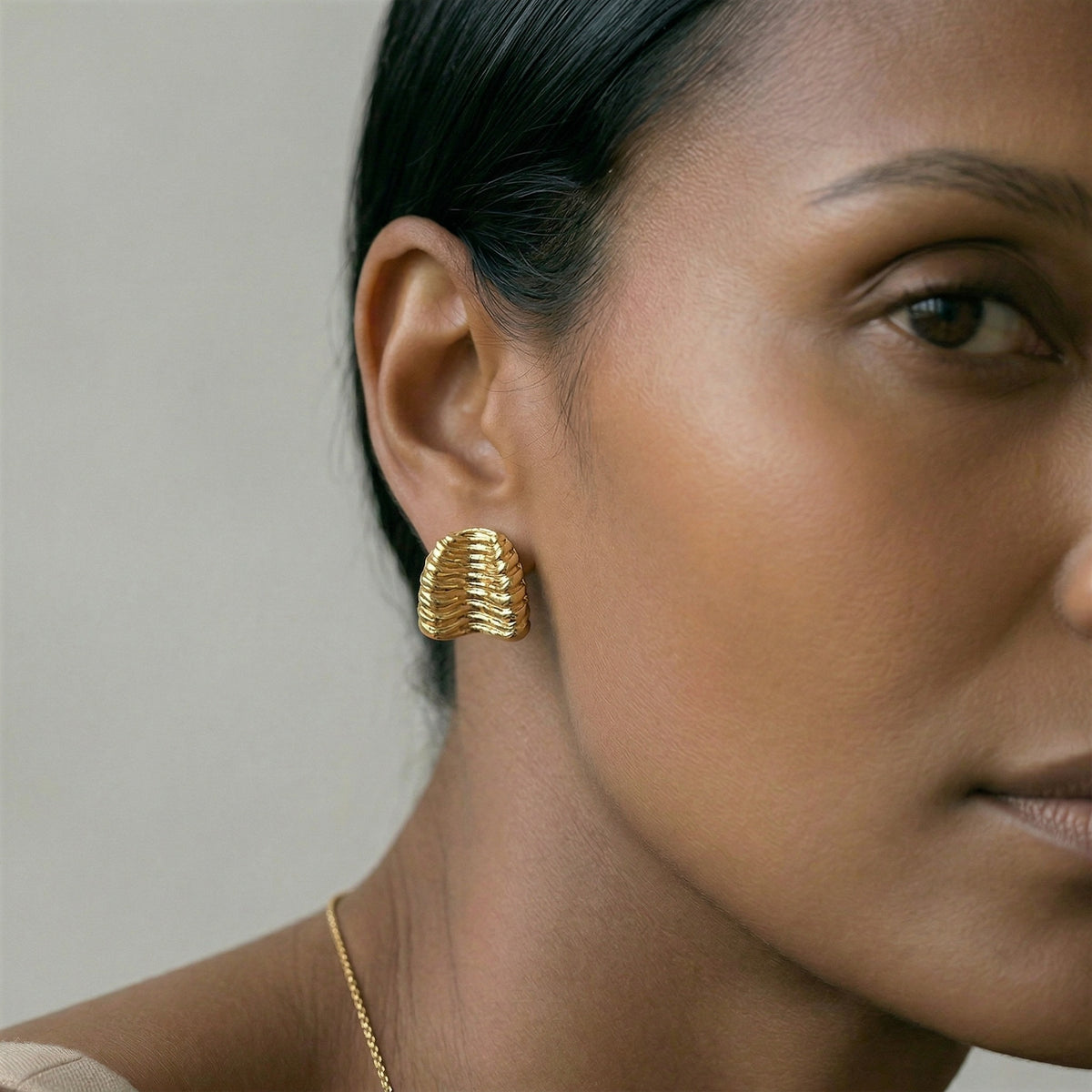 model wearing amethyst & sable calypso sculpt earrings in 18k gold