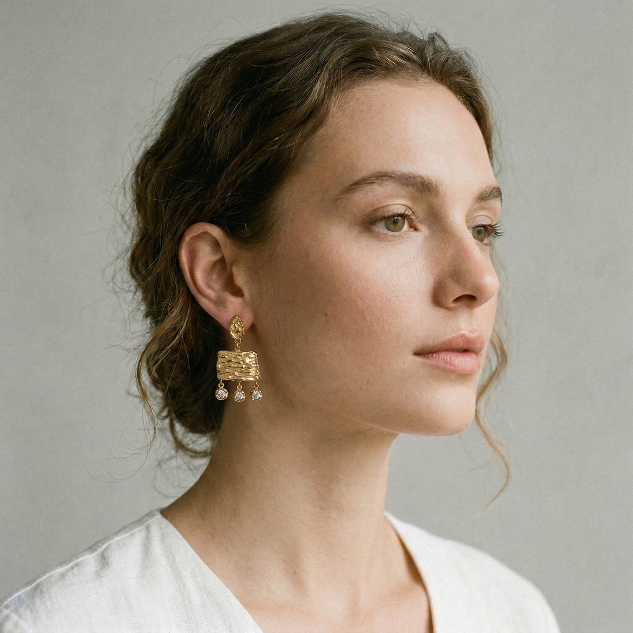 model wearing amethyst & sable calypso solara tassel earrings in 18k gold