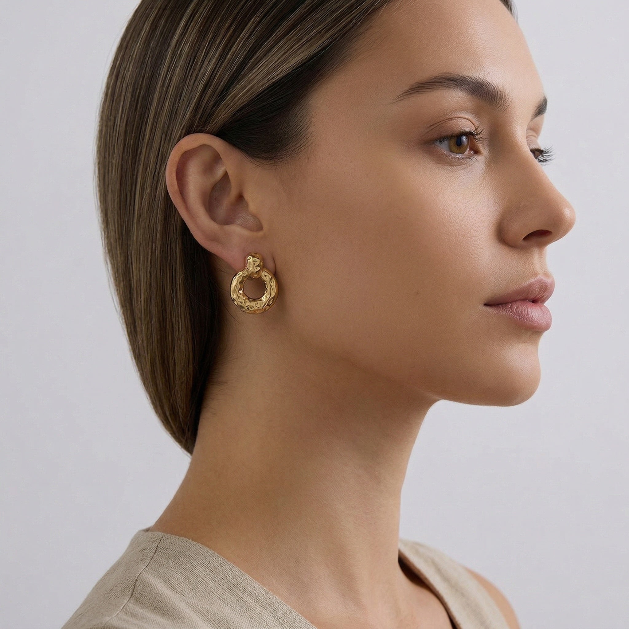 model wearing amethyst & sable calypso textured earrings in 18k gold