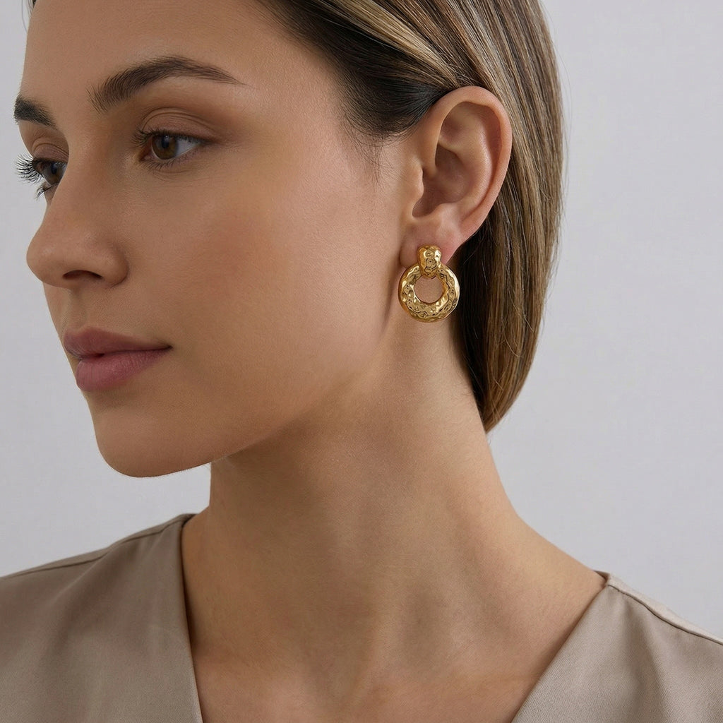 model wearing amethyst & sable calypso textured earrings in 18k gold