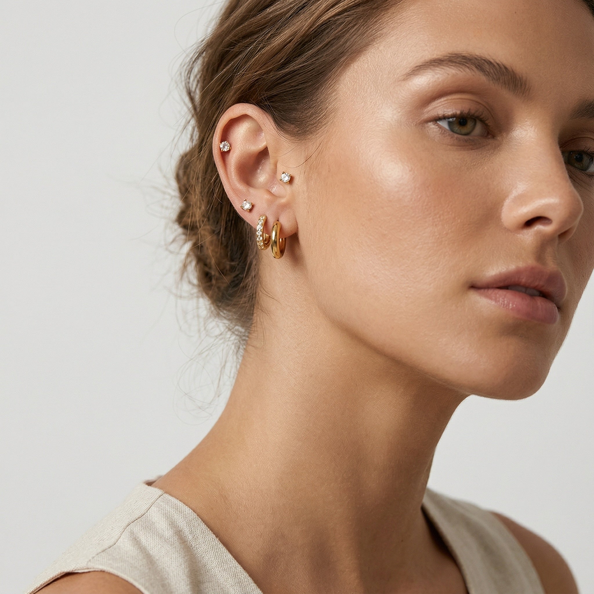 model wearing amethyst & sable luma ear stack set in 18k gold