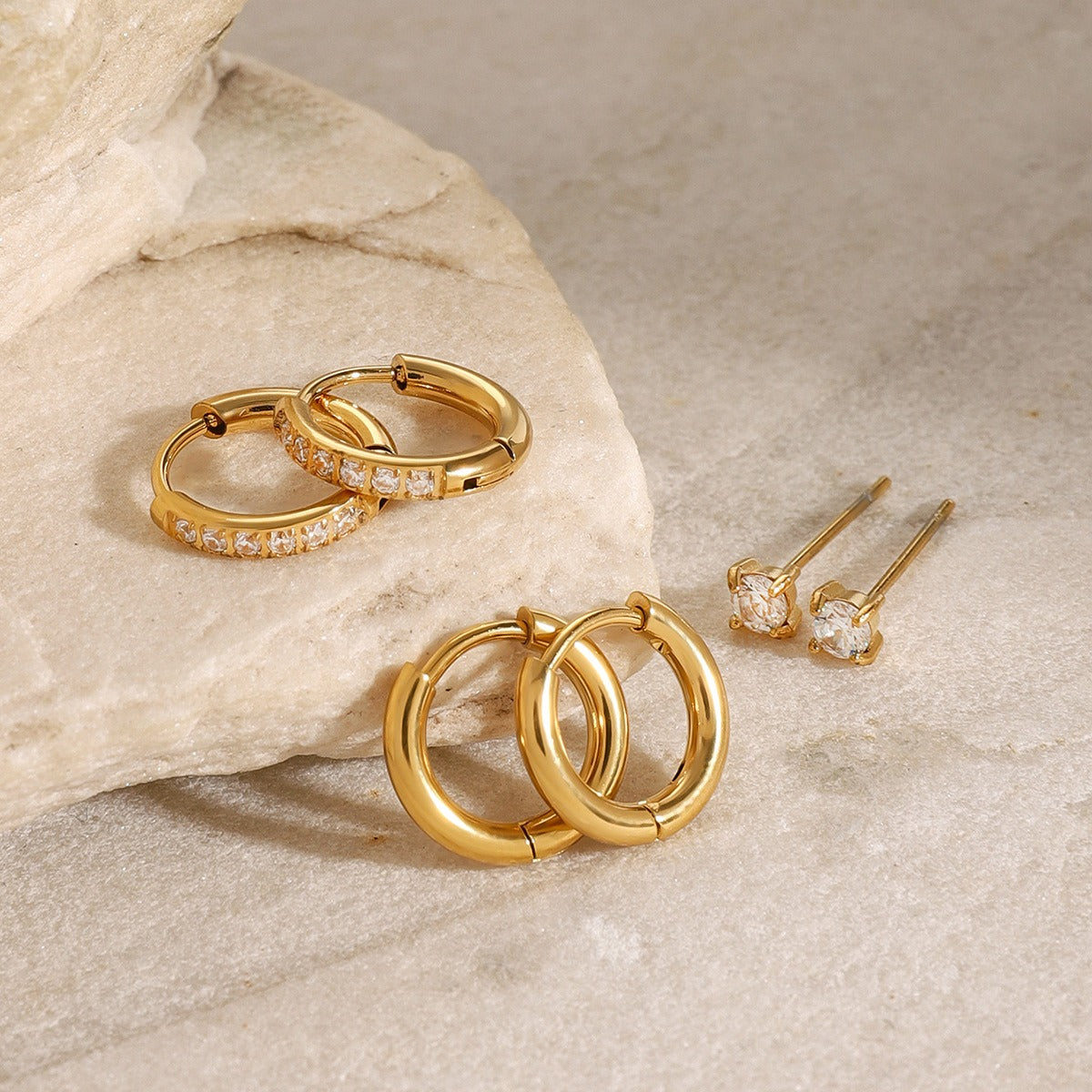 amethyst & sable luma ear stack set in 18k gold on stone surface