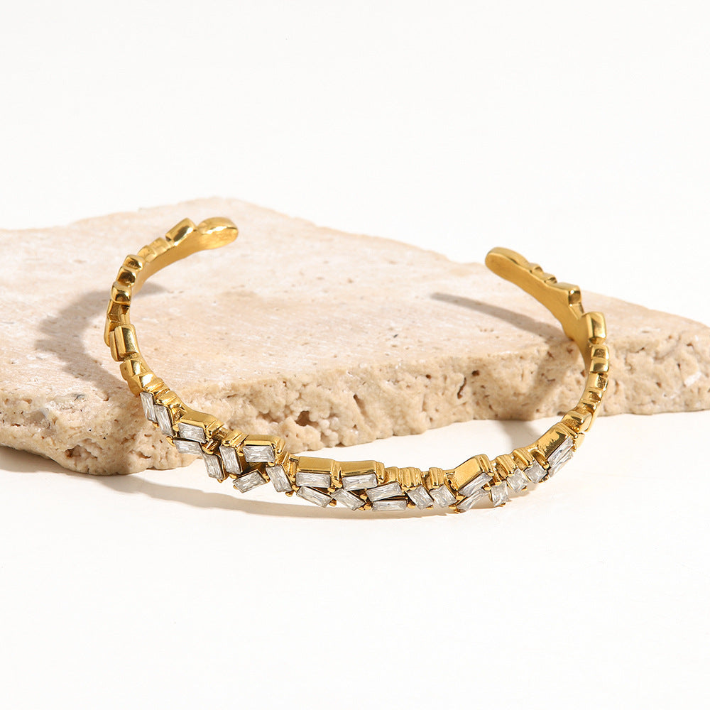 amethyst & sable luma prism bangle in gold on stone surface