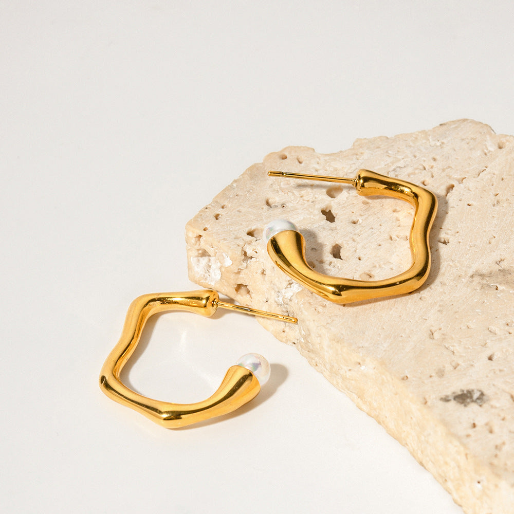 amethyst & sable selene orbit pearl hoops in 18k gold on stone surface