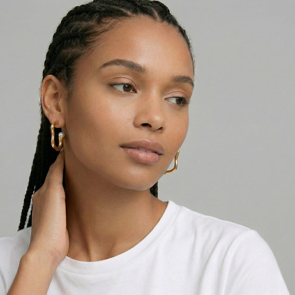model wearing amethyst & sable selene orbit pearl hoops in 18k gold