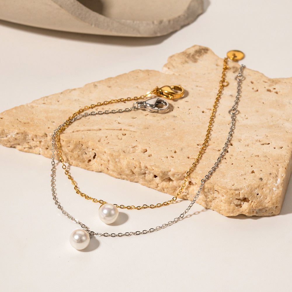 amethyst & sable selene pearl drop bracelets in gold and silver on stone