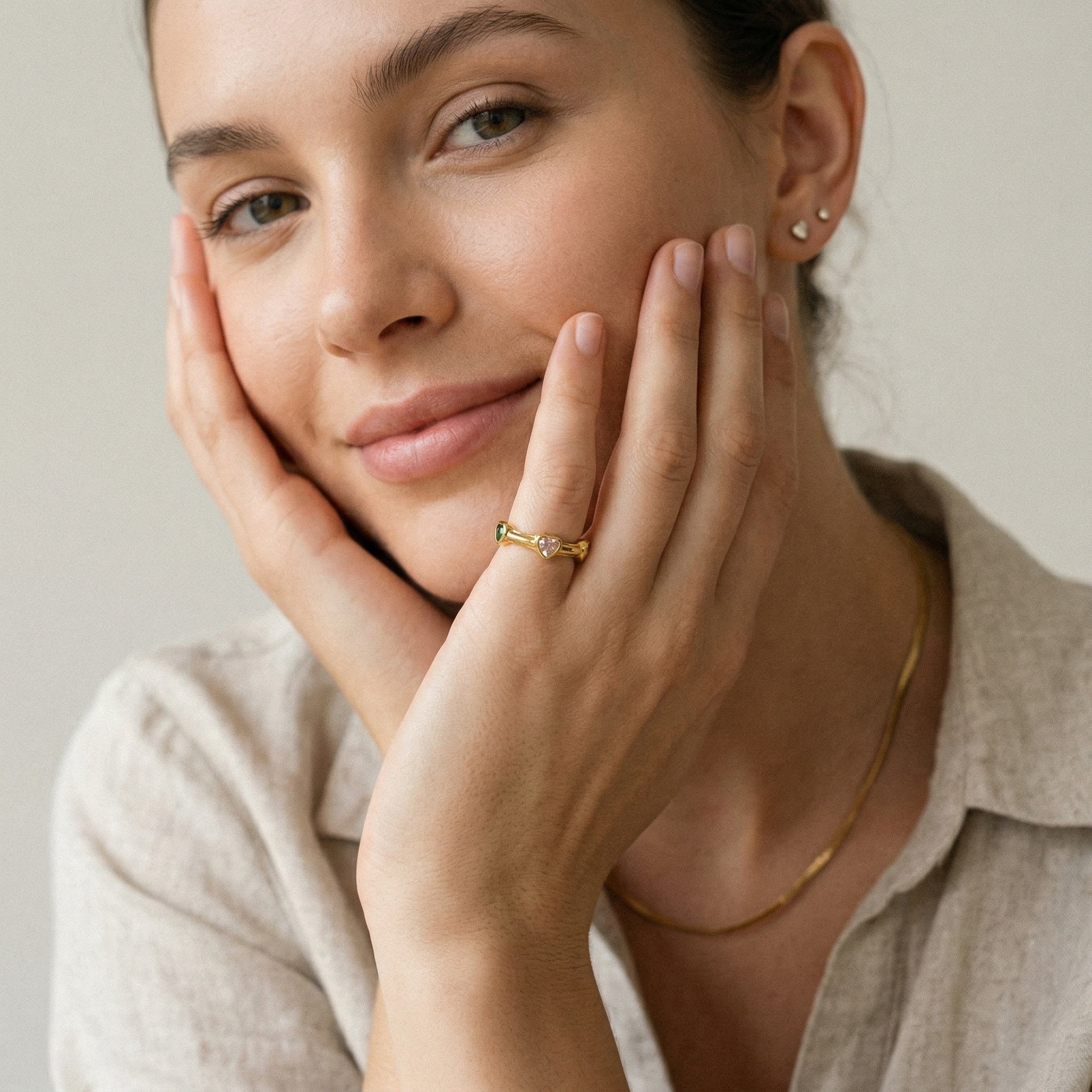 model wearing amethyst & sable soleil amora ring in gold with heart gemstones
