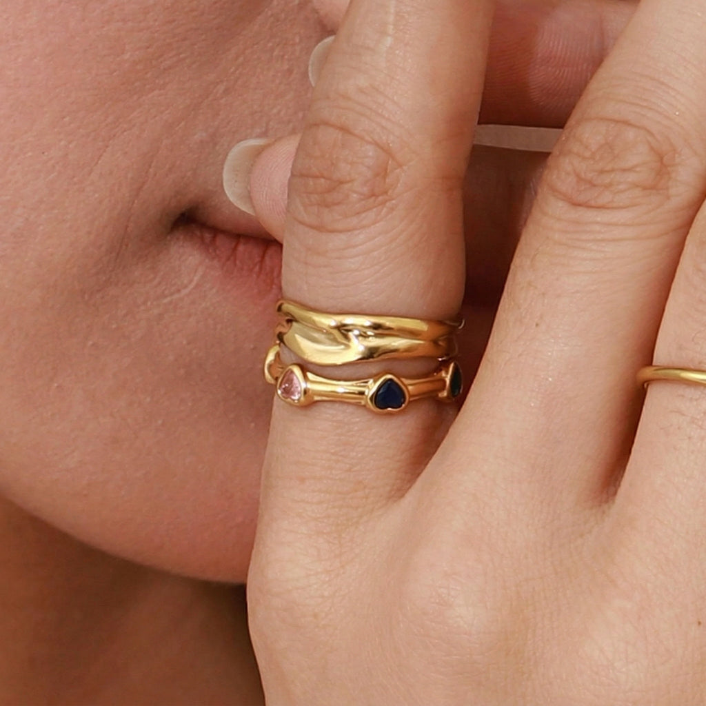 model wearing amethyst & sable soleil amora ring in gold with heart gemstones