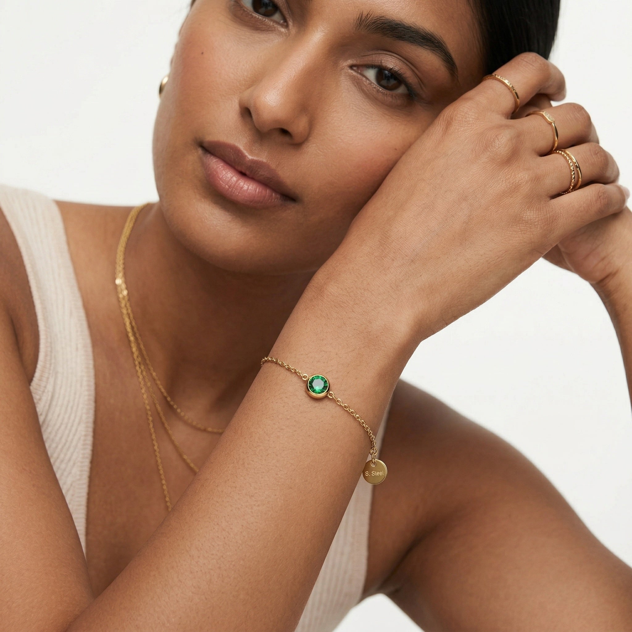 model wearing amethyst & sable soleil halo bracelet in 18K gold emerald