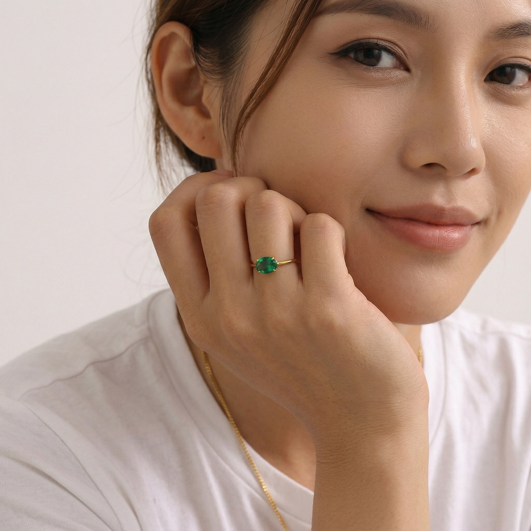 model wearing gold amethyst & sable soleil meridian ring in emerald