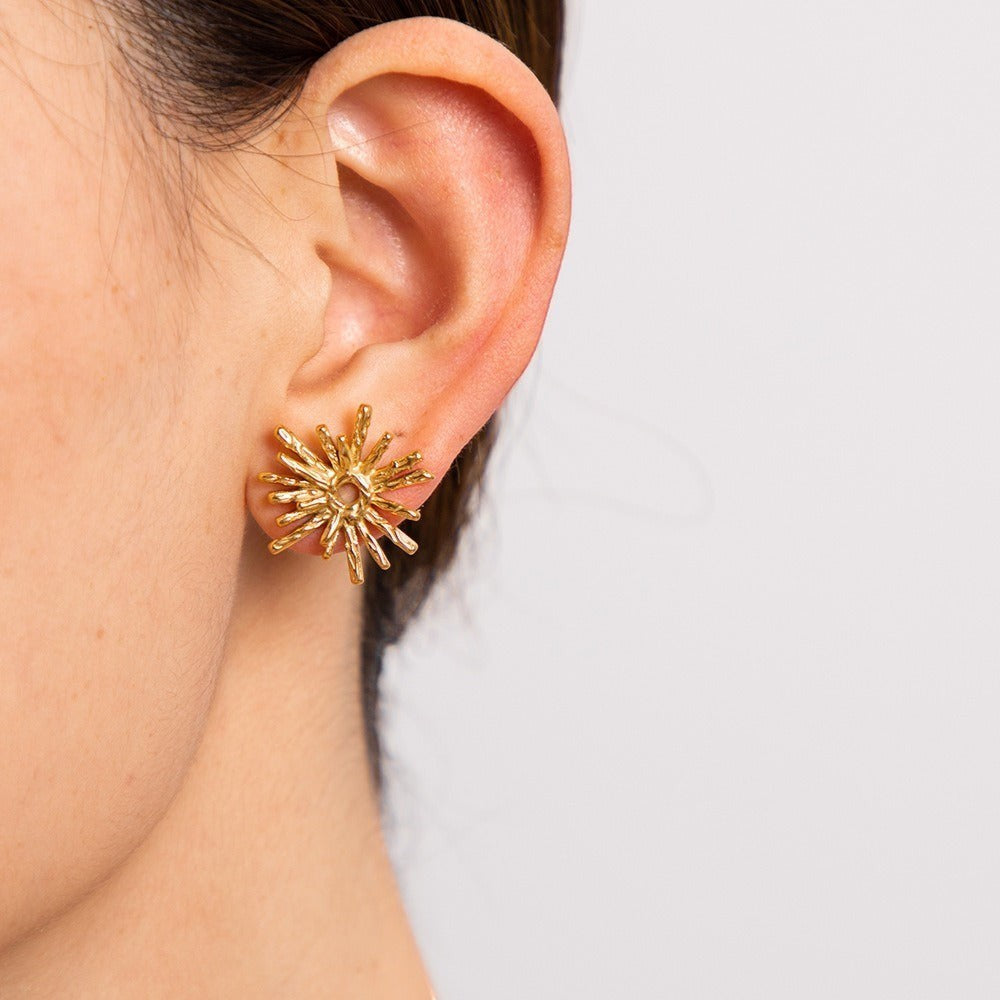 model wearing amethyst & sable sunburst stud earrings in 18k gold