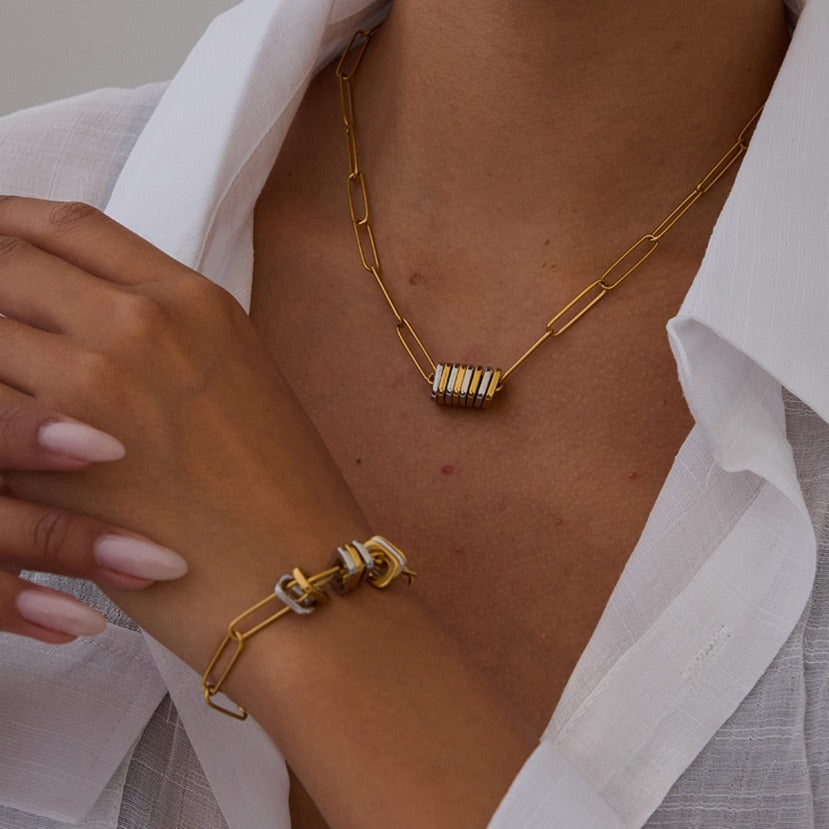 amethyst & sable's axis circuit set in mixed metal on person wearing a white shirt.