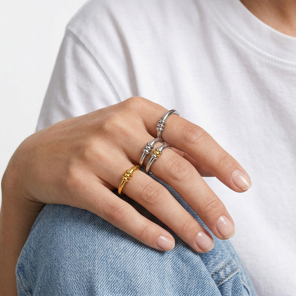 model wearing amethyst & sable axis trinity ring collection