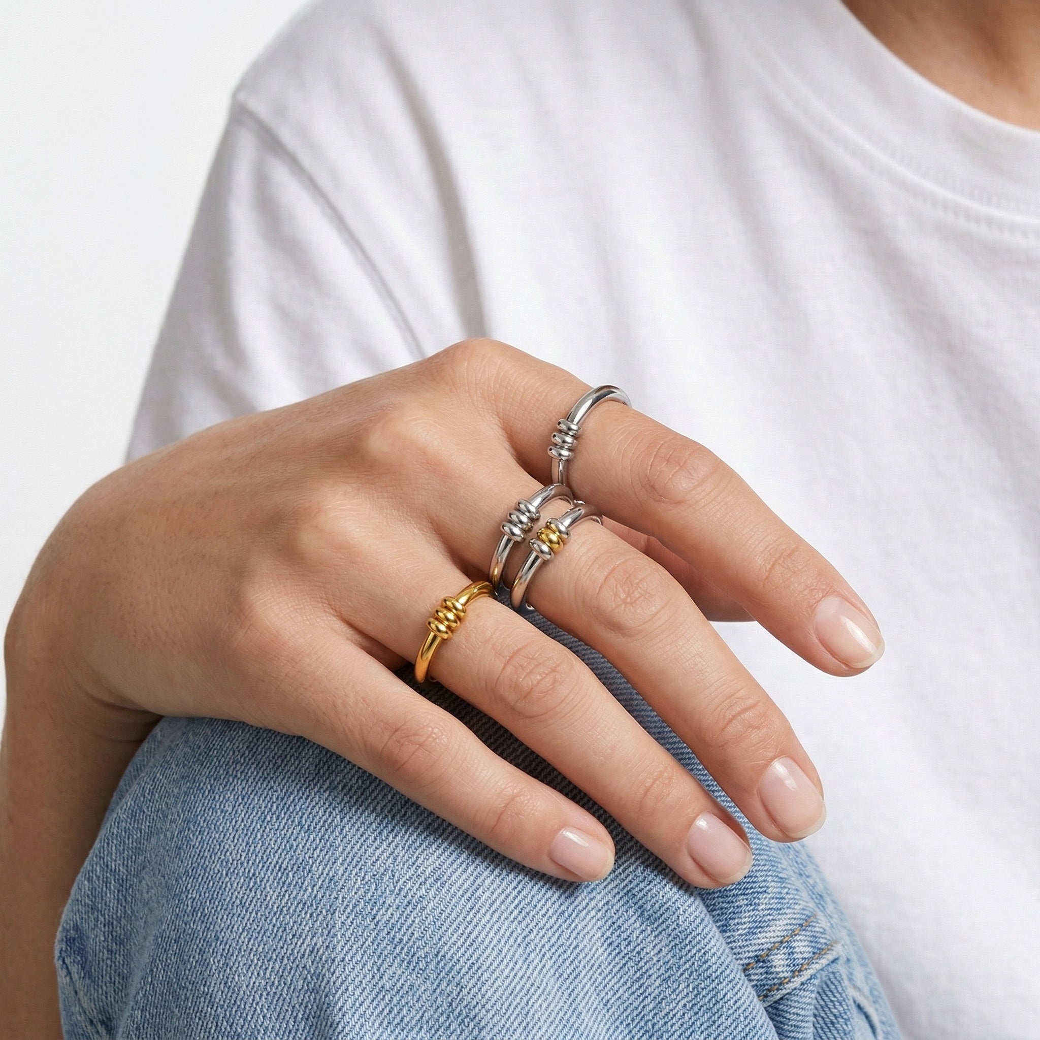 model wearing amethyst & sable axis trinity ring collection
