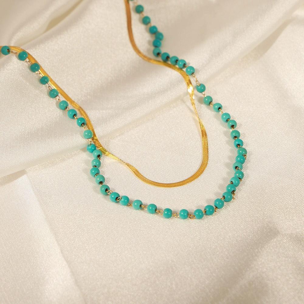amethyst & sable calypso azure necklace in 18k gold on silk ivory fabric