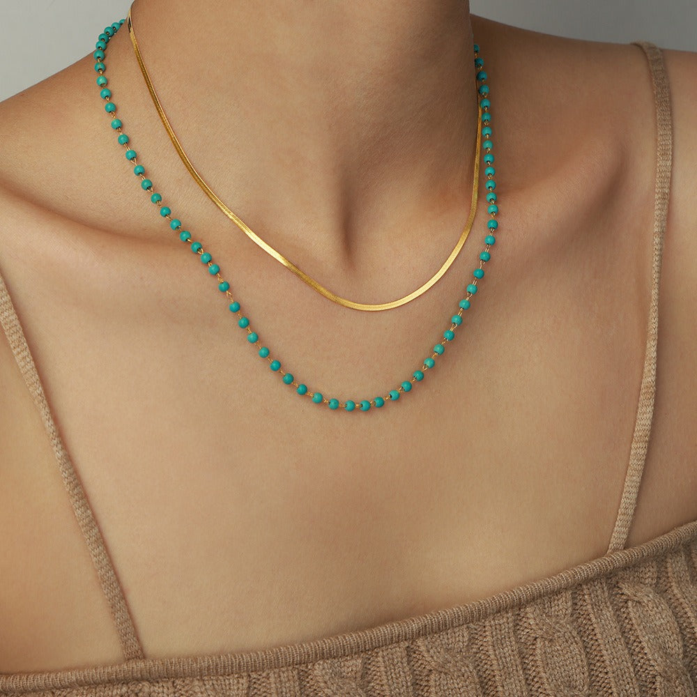 model wearing amethyst & sable calypso azure necklace in 18k gold