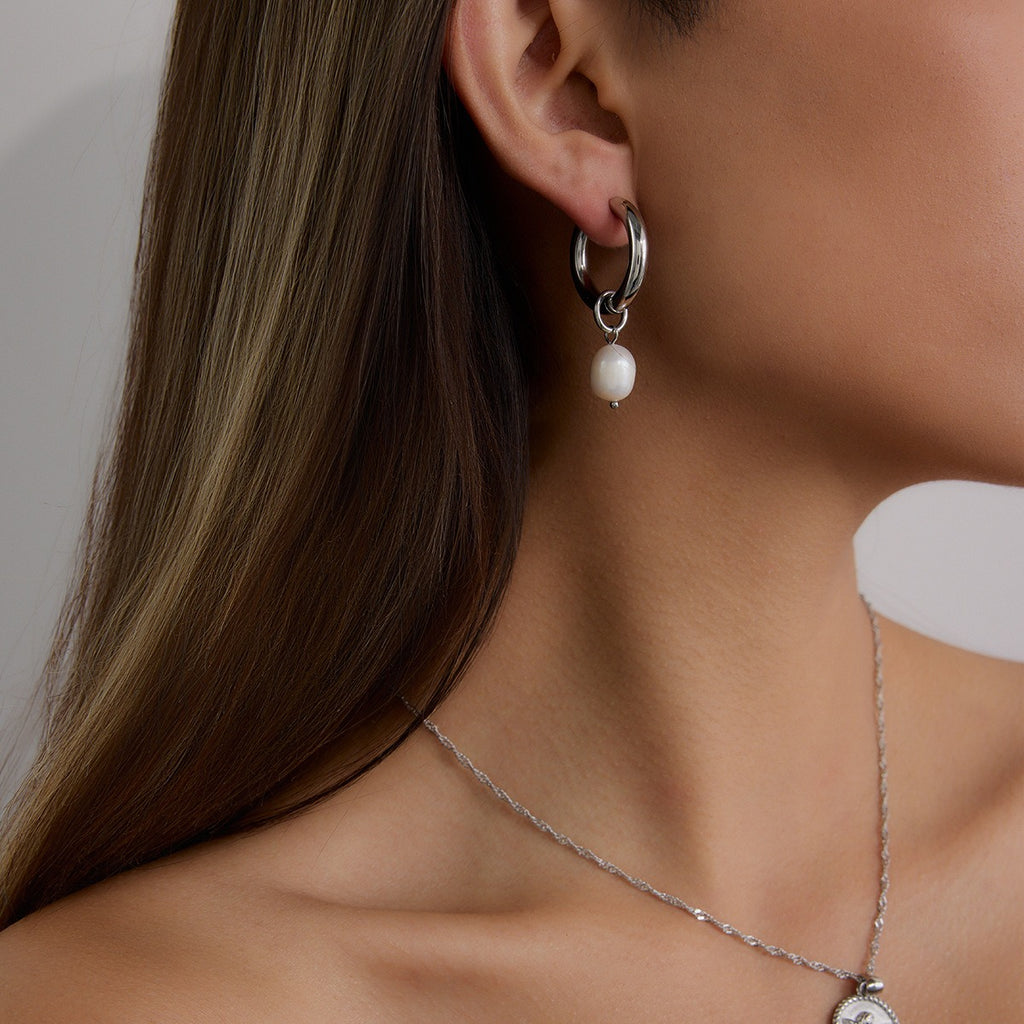 model wearing amethyst & sable Selene Pearl Drop Hoops in silver