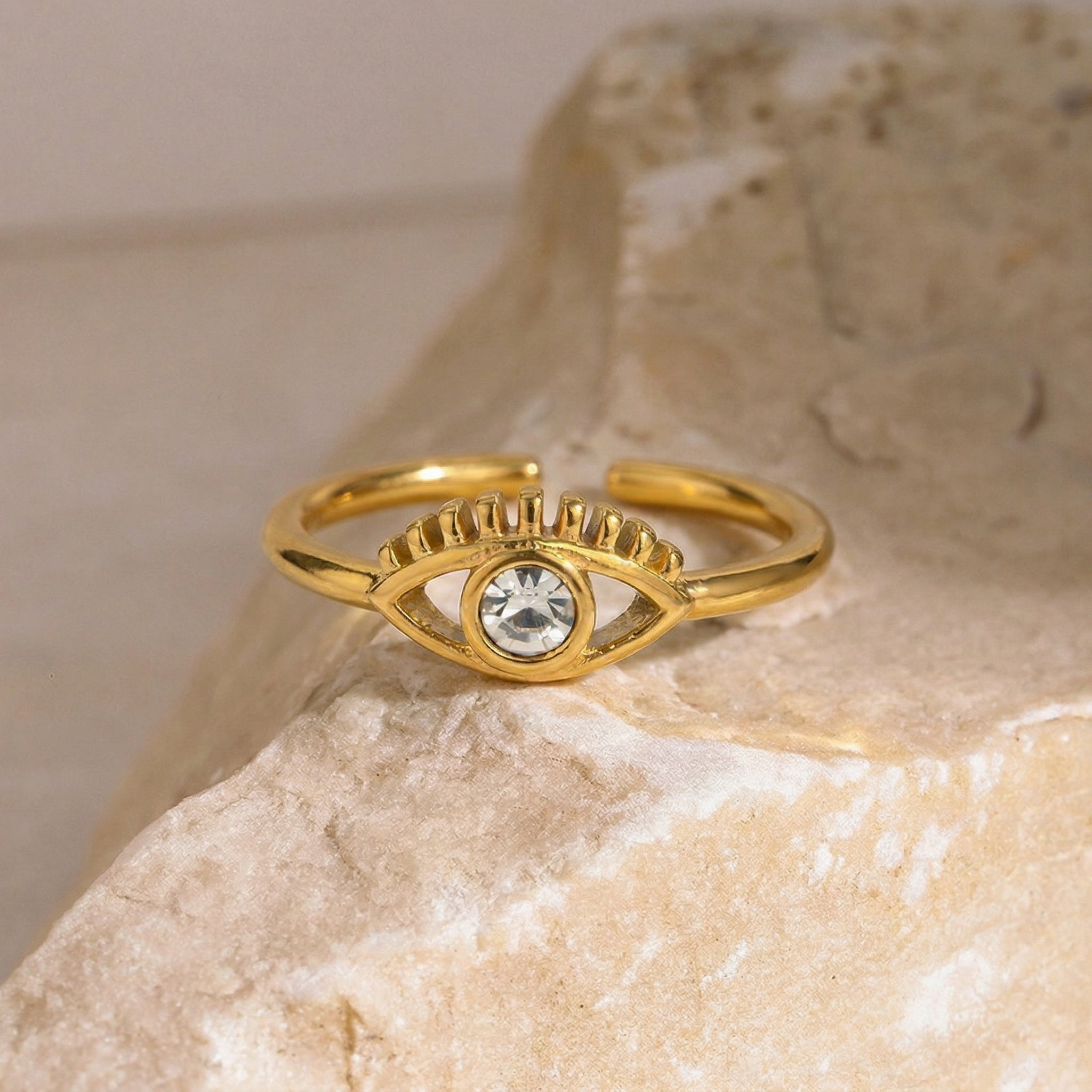 amethyst & sable luma beacon ring in 18k gold on stone surface