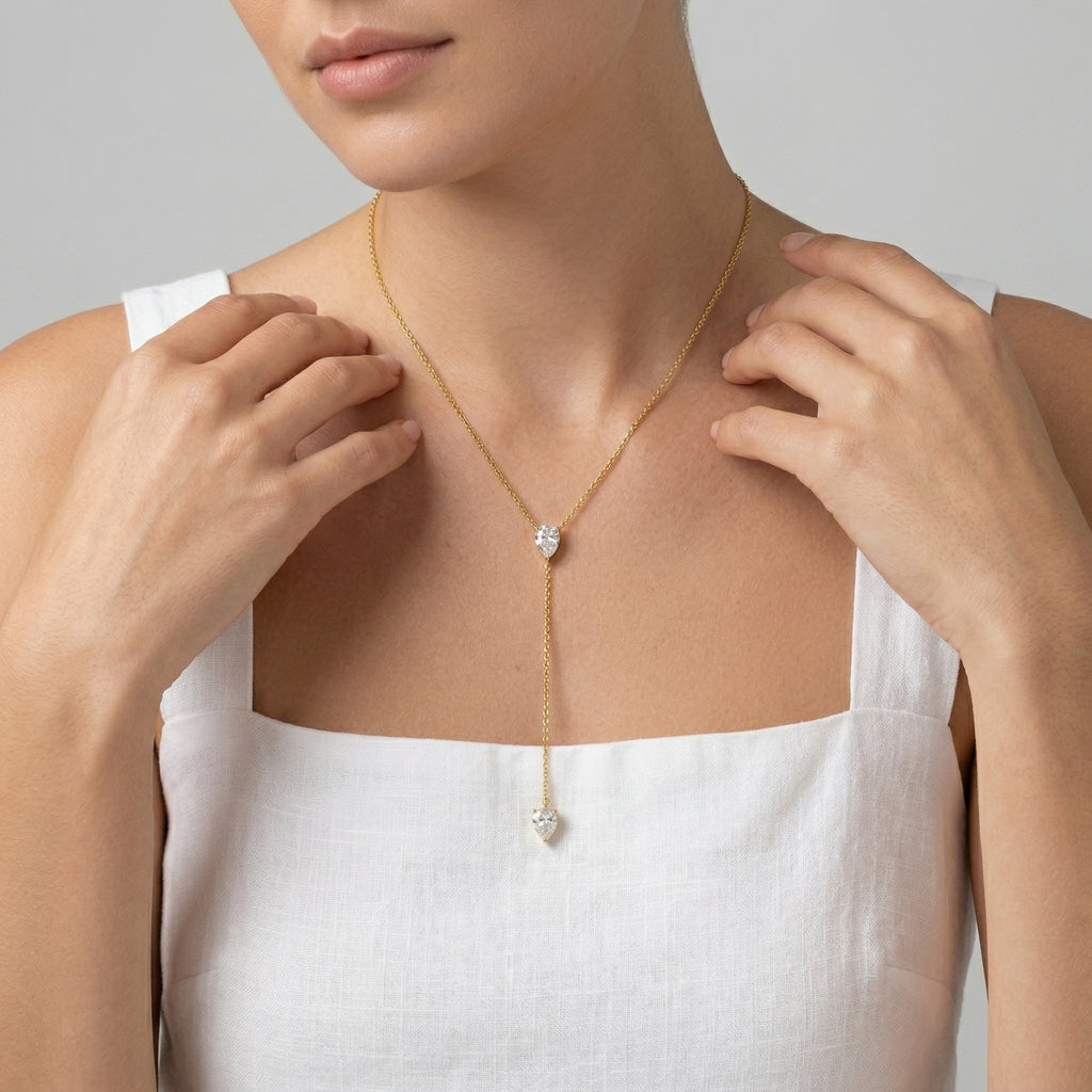 model wearing amethyst & sable luma lariat necklace in 18k gold with pear-shaped cubic zirconia stones