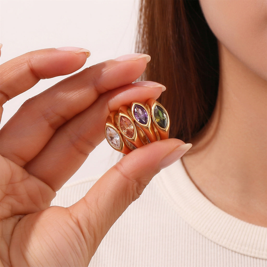 model holding amethyst & sable luma marquise signet ring collection in 18k gold
