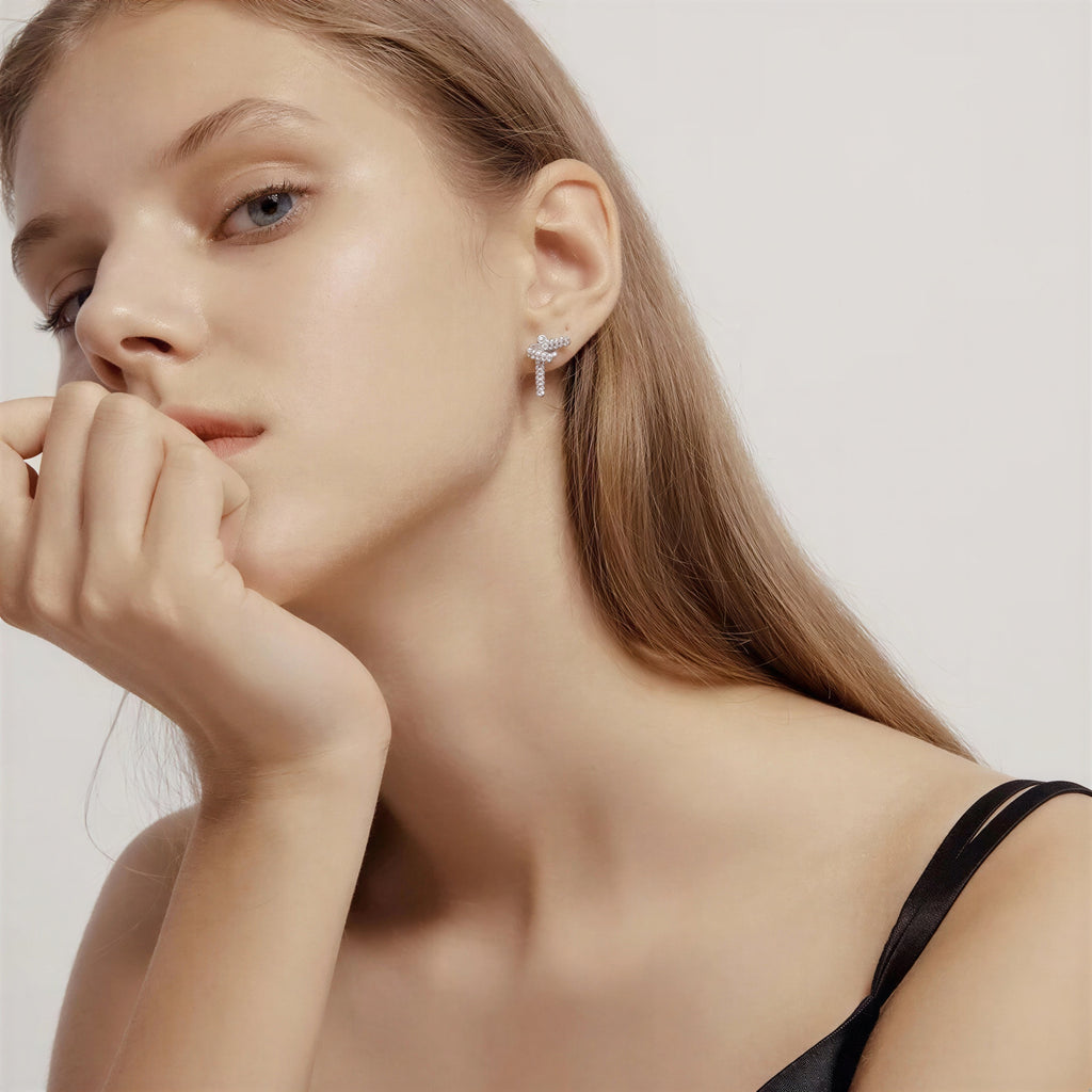 model wearing amethyst & sable luma knot earrings in silver