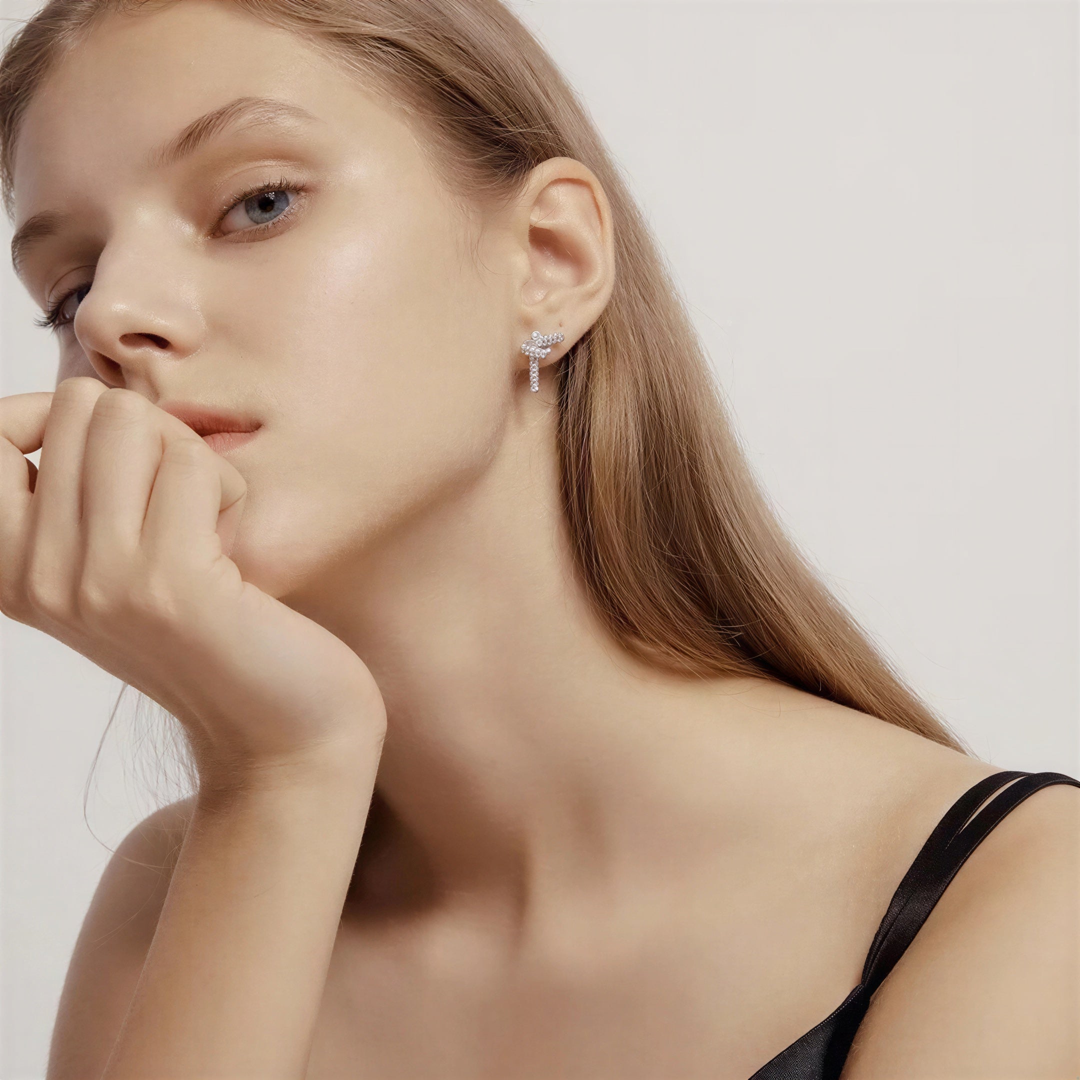 model wearing amethyst & sable luma knot earrings in silver