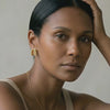model wearing amethyst & sable calypso sculpt earrings in 18k gold